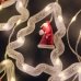 Світлодіодна гірлянда-завіса прозорий дріт Фігурки в ялинці 10 LED Magic Lights 3 х 0.6 м теплий білий